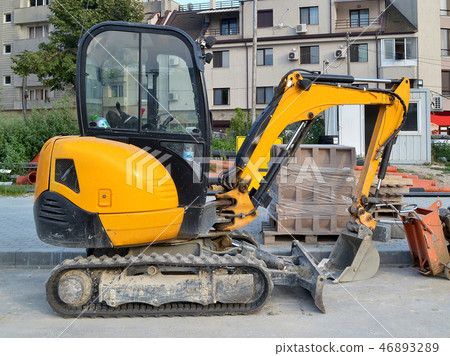 Yellow mini excavator on tracks Yellow mini excavator on tracks 46893289