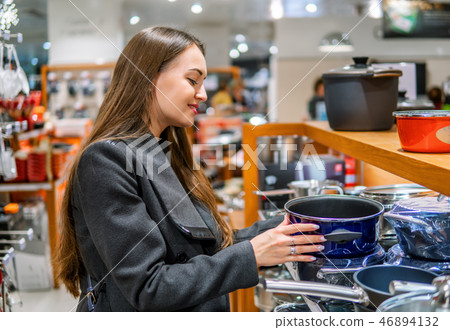 beautiful woman choosing utensil dishes in a store supermarket beautiful woman choosing utensil dishes in a store supermarket 46894132