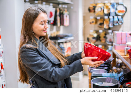woman choosing utensil dishes in a store supermarket 46894145