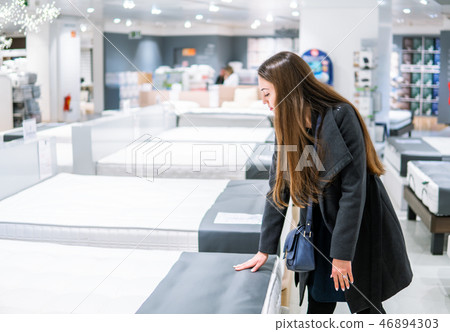 Customer woman buying new furniture - bed in a store 46894303