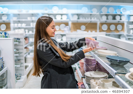 woman choosing utensil dishes in a store supermarket woman choosing utensil dishes in a store supermarket 46894307