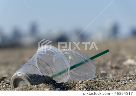 [Image] Garbage dumped on sandy beach Plastic cup straw 46894517
