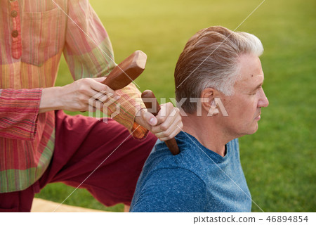 Thai massage by wood hammer for treat. Thai massage by wood hammer for treat. 46894854