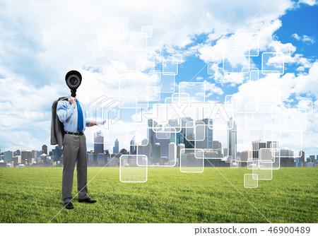 Camera headed man standing on green grass against modern cityscape 46900489