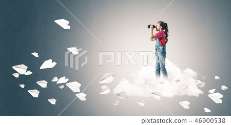 Concept of careless happy childhood with girl looking in binocul Concept of careless happy childhood with girl looking in binocul 46900538