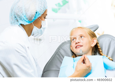 Dentist inspecting patient Dentist inspecting patient 46900602