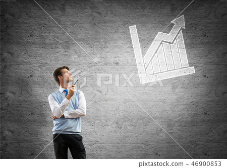 Elegant handsome businessman against concrete wall with pipe in hand Elegant handsome businessman against concrete wall with pipe in hand 46900853