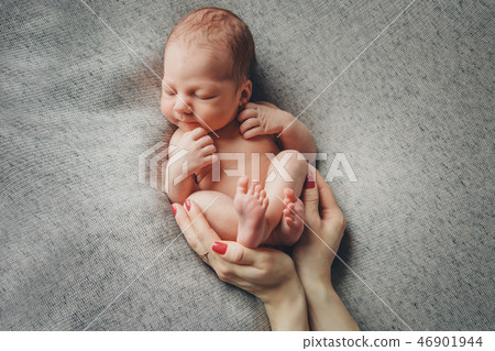 newborn baby lying on the hands of parents newborn baby lying on the hands of parents 46901944