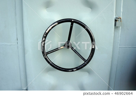 Black water tight handle of metal door on a ship 46902664