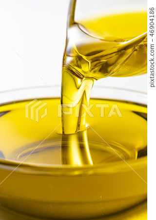 Pour olive oil into the bowl Pour olive oil into the bowl 46904186