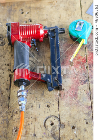 Carpenters are using tools with wood . Carpenters are using tools with wood . 46906363