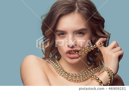 Beautiful young girl in studio with pearl jewelry - earrings, bracelet, necklace. 46909281