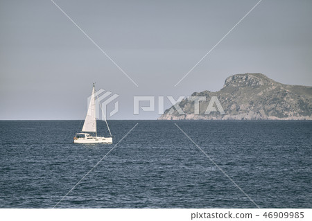 Lonely sailboat at the sea. Lonely sailboat at the sea. 46909985