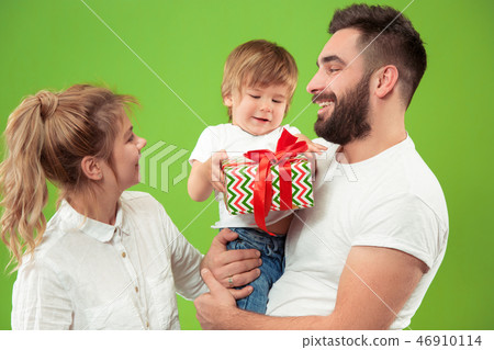 happy family with kid together and smiling at camera isolated on green 46910114