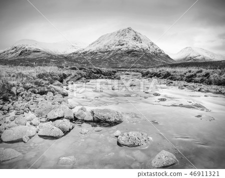 River at base of snowy mountains in Scottland River at base of snowy mountains in Scottland 46911321