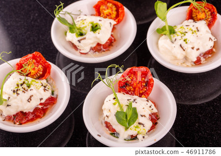 Tartlets from cheese mozzarella with tomatoes drie Tartlets from cheese mozzarella with tomatoes drie 46911786