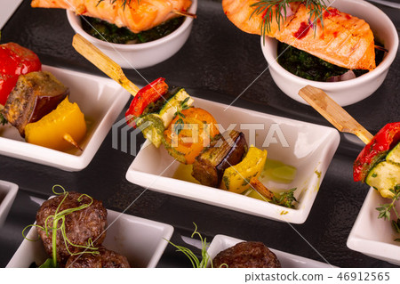 Stewed vegetables on a skewer under green oil 46912565