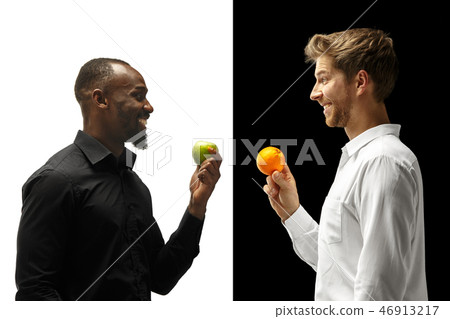 Men eating a fruits on a black and white background Men eating a fruits on a black and white background 46913217