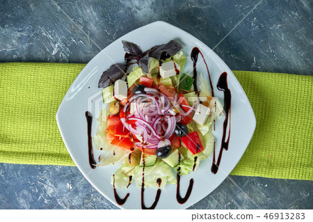 Greek salad with fresh vegetables, feta cheese and black olives Greek salad with fresh vegetables, feta cheese and black olives 46913283