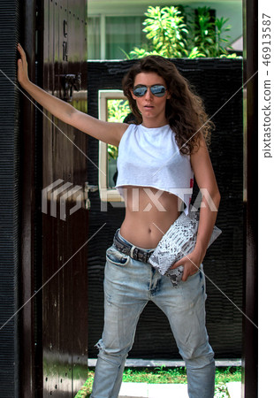 beautiful fashionable girl posing in street with beautiful body is near expensive villa.Model 46913587