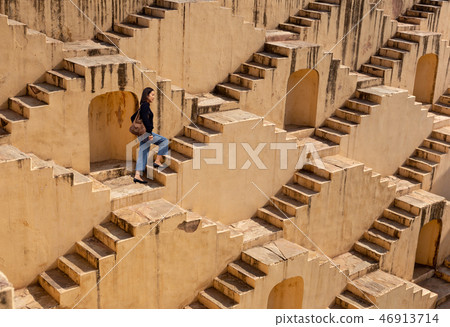 Womanm walking on stepwells of Chand Baori in Jaipur India. 46913714