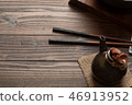 Chinese chopstick with cray tea jar on wooden  46913952