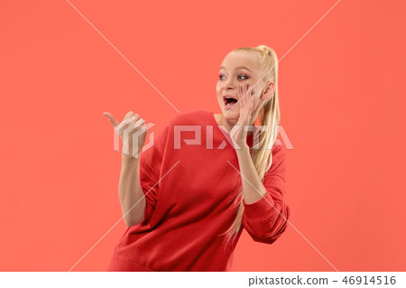 Isolated on coral young casual woman shouting at studio Isolated on coral young casual woman shouting at studio 46914516
