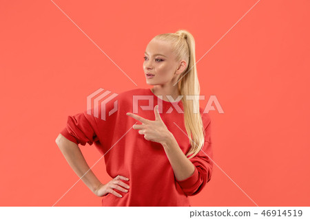 Isolated on coral young casual woman shouting at studio Isolated on coral young casual woman shouting at studio 46914519