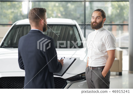 Manager selling client auto in car center. Manager selling client auto in car center. 46915241