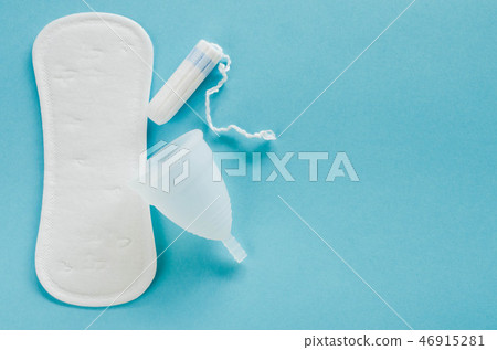 Menstrual cup, sanitary pad and tampon on a blue 46915281