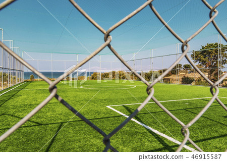 Outdoor Football Pitch Behind Fence With Sea 46915587