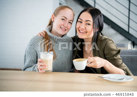 Females enjoying with cup of coffee in cafeteria 46915848