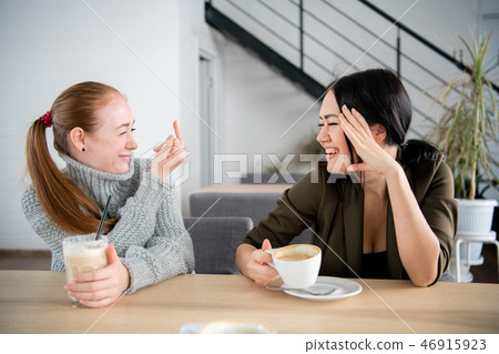 women giving rude middle finger hand gesture to her best friend having fun women giving rude middle finger hand gesture to her best friend having fun 46915923
