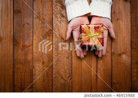 Women's hand with gifts 46915988