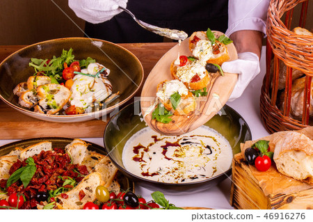 Bread on a wooden board with cheese sauce 46916276