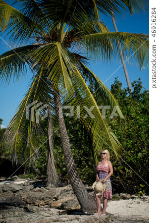 Young sexy blonde woman in beach dress near sea Young sexy blonde woman in beach dress near sea 46916284