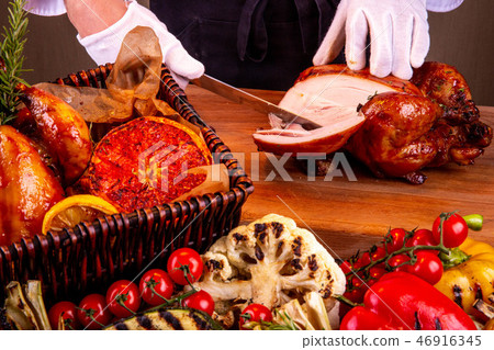 Cutting of chicken on a part on a wooden board 46916345