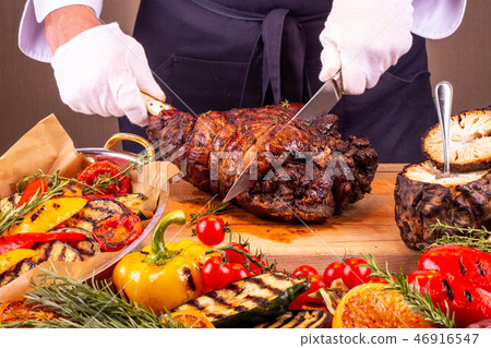 The cook cuts hough pork on a chopping board The cook cuts hough pork on a chopping board 46916547