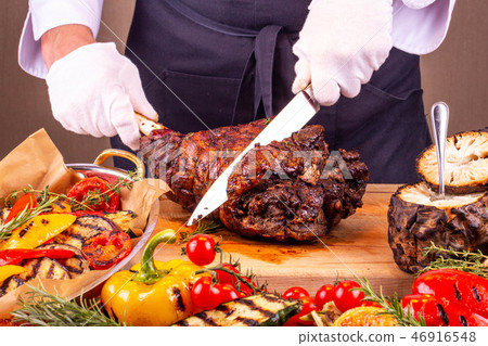 Cutting of pork hough on a wooden board Cutting of pork hough on a wooden board 46916548