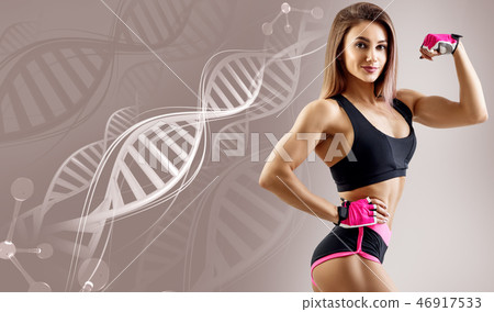 Athletic fitness woman standing among DNA chains. 46917533