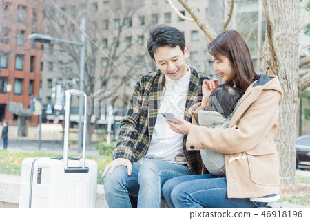 Couple looking at smartphone at travel destination Couple looking at smartphone at travel destination 46918196