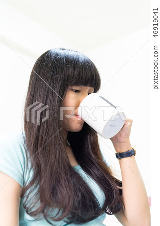One female lady sitting on the water. Water replenishment. Twenty young youth women. 46919041