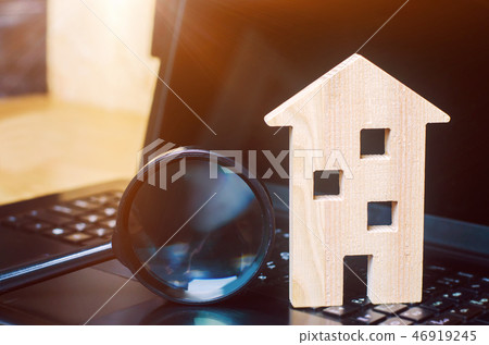 House and magnifying glass on the keyboard. House and magnifying glass on the keyboard. 46919245