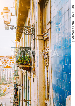Traditional facade front of portuguese buildings with balconys and lamps. Old charming street in Traditional facade front of portuguese buildings with balconys and lamps. Old charming street in 46922883