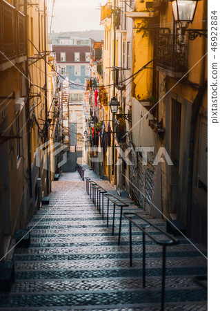 Beautiful Staircase in Lisbon. Hanging laundry in typical narrow street. Sunset in the old downtown 46922884