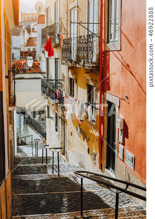 Portuguese old street. Hanging laundry at Sunset in the historical downtown of Lisbon, cityscape of 46922888