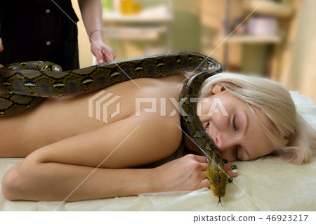 Non-toxic python on female body. Non-toxic python on female body. 46923217