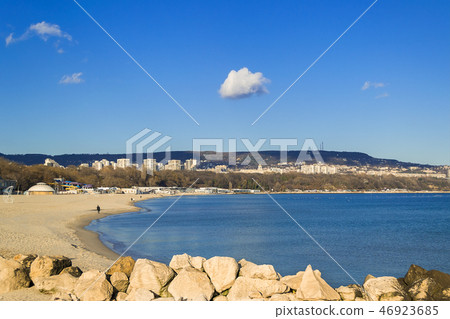 One cloud high in the blue sky over seashore city 46923685