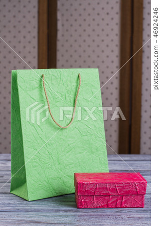 Green shopping bag and pink gift box. Green shopping bag and pink gift box. 46924246