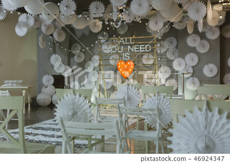 Wooden arch and chairs at wedding ceremony with words all you need is love Wooden arch and chairs at wedding ceremony with words all you need is love 46924347